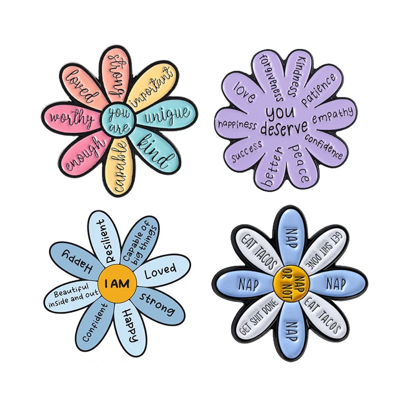 A set of enamel pins featuring daisy flower designs with positive affirmations like loved worthy unique kind important and su