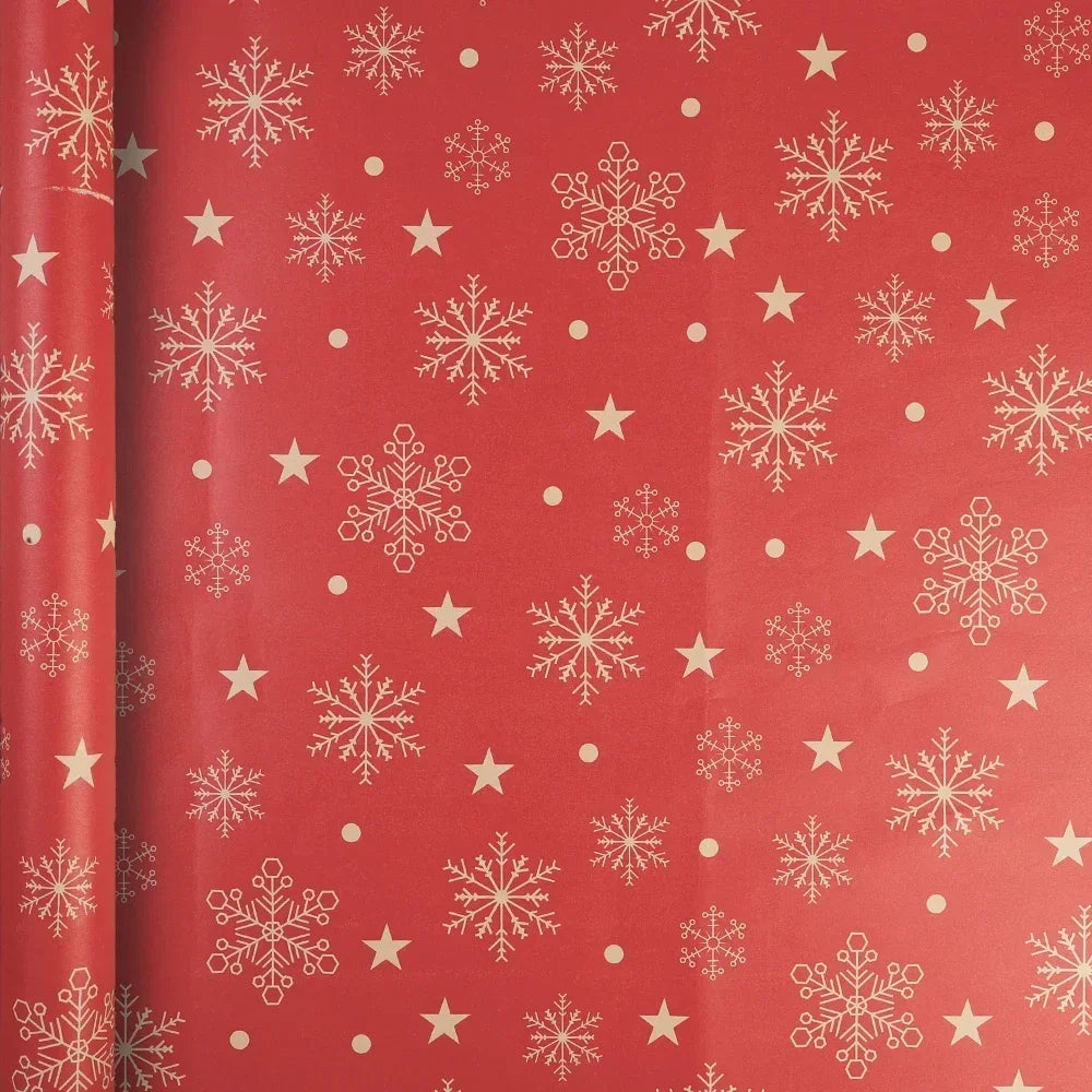 A roll of festive Christmas wrapping paper featuring white snowflakes and gold stars on a red background.