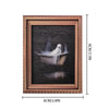 A framed picture featuring a white ghost floating above dark water, used as Halloween decor.