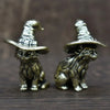 A pair of vintage brass cat statues, featuring detailed feline figures in a stylized witch hat design.