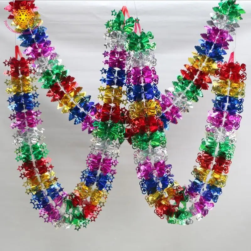 A shimmering tinsel garland ribbon in various colors is shaped like the letter M for Christmas tree and party decor.