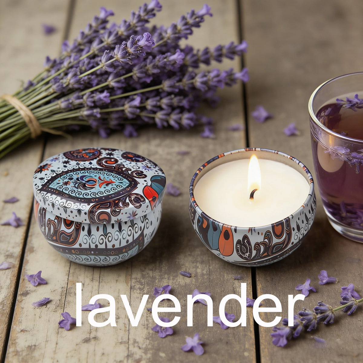 A small candle in a glass holder surrounded by lavender flowers and a tin labeled lavender.