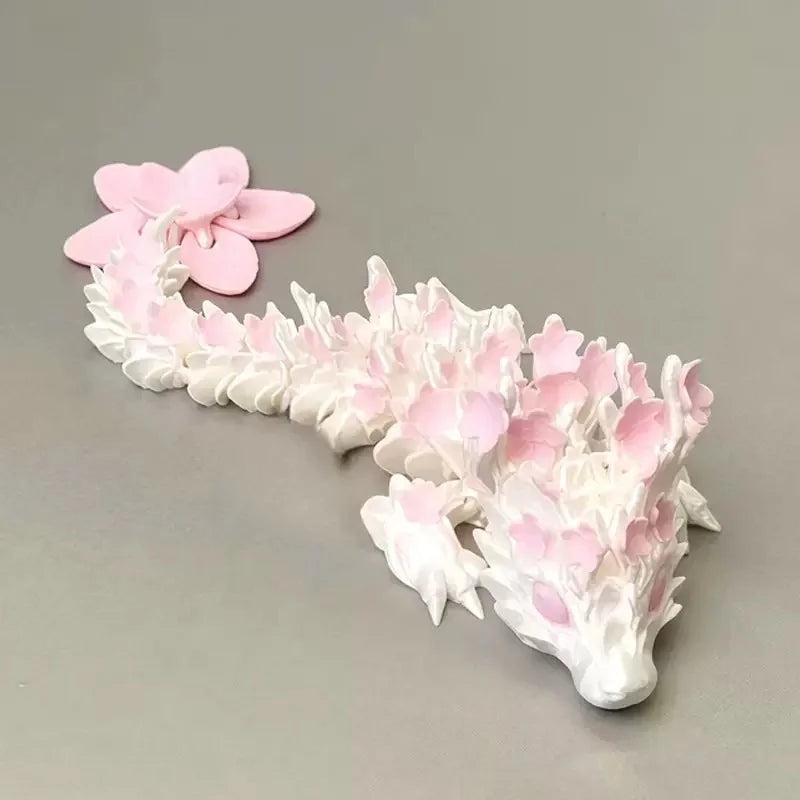 A miniature figurine of a dragon made from pink and white cherry blossoms.
