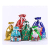 A set of five festive drawstring Christmas gift bags featuring Santa and snowman designs in gold, red, green, blue, and white
