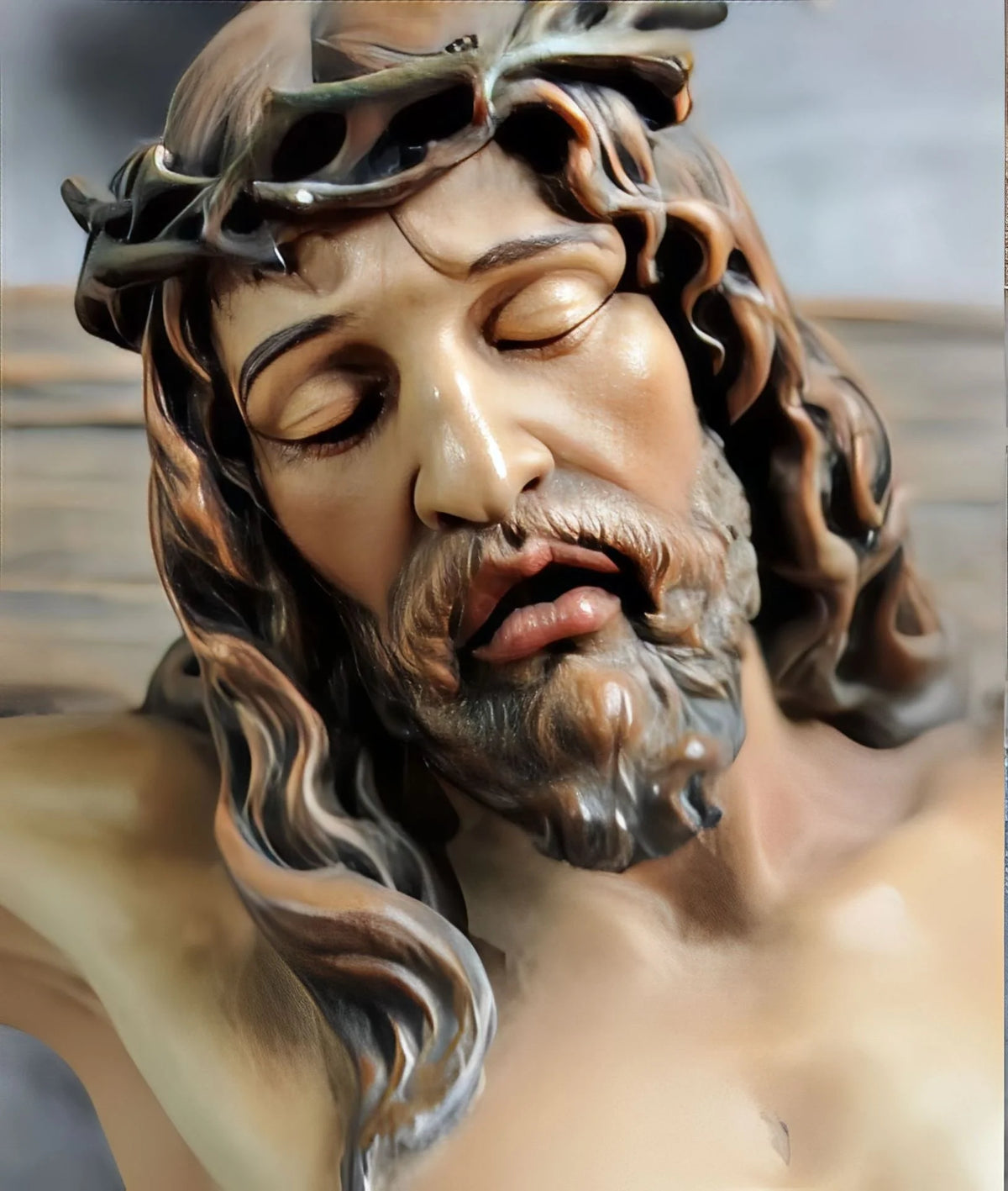 A realistic resin figurine of Jesus with a crown of thorns and long hair, depicting him in a sorrowful expression.