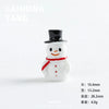 A small white resin snowman figurine with a black hat and a red scarf.