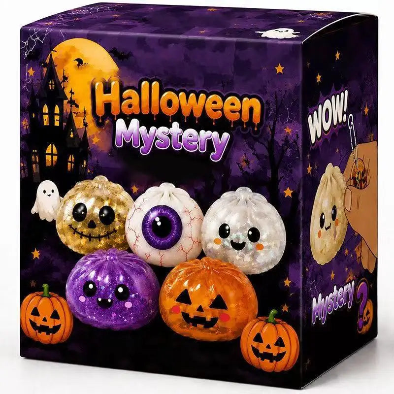 A box of Halloween Mystery toys featuring carved pumpkins and a ghost dumpling toy.