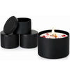 Black candle tin containers with lids holding a white candle and dried floral petals