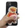 A hand holds a soft pink 3D Shiba Inu squishy sticker decal on a black smartphone.