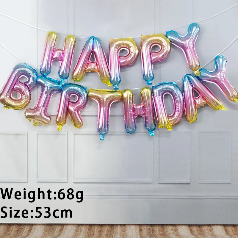 A string of 13 foil letter birthday balloons in various iridescent colors hangs against a white door.