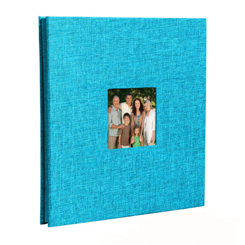 A teal linen front scrapbook memory book with a photo of a family.