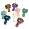 A collection of natural crystal pendants shaped like palm leaves in various colors including purple, orange, pink, green, blu