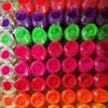 A collection of 13 vivid neon fluorescent pigment powders in various shades of pink, green, purple, and orange.