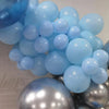 A cluster of light blue and silver balloons forming a decorative arch or grouping for party use.