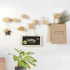A collection of decorative wooden animal hooks, including a deer, a cat, and a bear, mounted on a white wall.