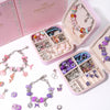 A pink jewelry organizer kit featuring various beads, charms, and bracelets for DIY making.