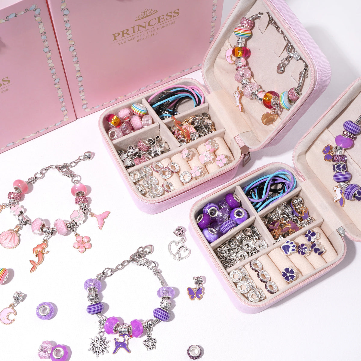 A pink jewelry organizer kit featuring various beads, charms, and bracelets for DIY making.