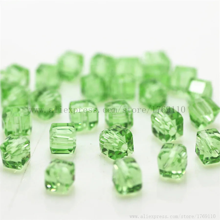 A collection of square cut green glass crystal beads for jewelry making