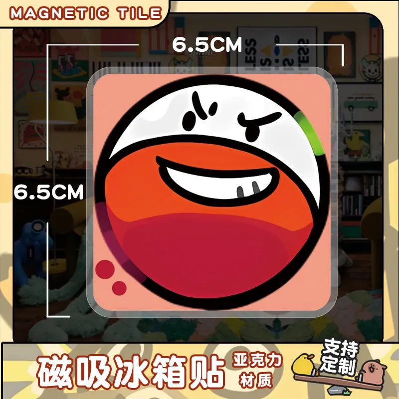 A close-up of a round, orange and white emoji-style magnet on a square tile.