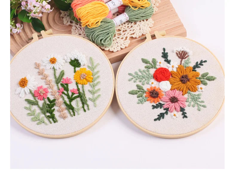 Punch needle embroidery kit featuring floral designs on stamped cloth with tools and yarn