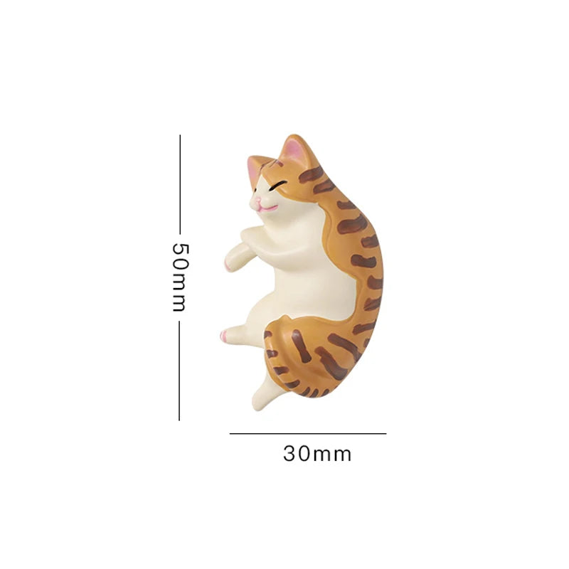 A cute, cream-colored cat figurine with orange stripes, shown in profile against a white background.