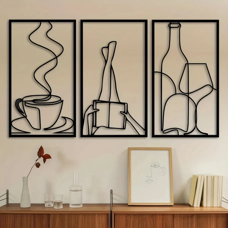 Three framed minimalist line art prints depicting a cup, a pen, and a wine glass on a light wall.