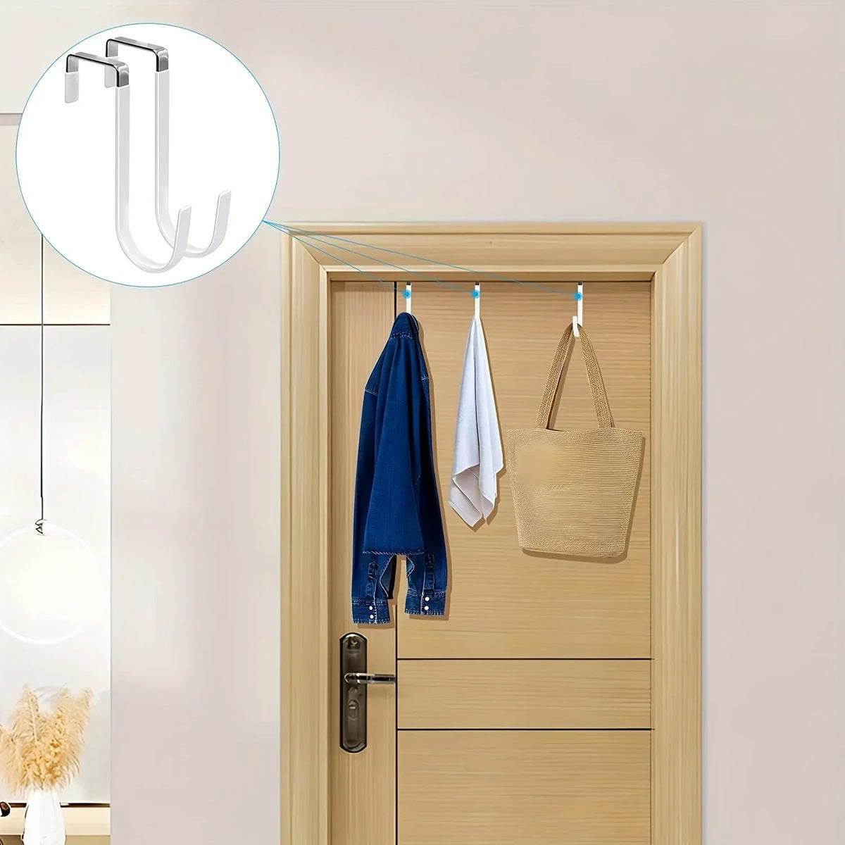 Heavy-duty door hangers with scratch-protective rubber coating hanging blue and white towels and a beige bag on a wooden door