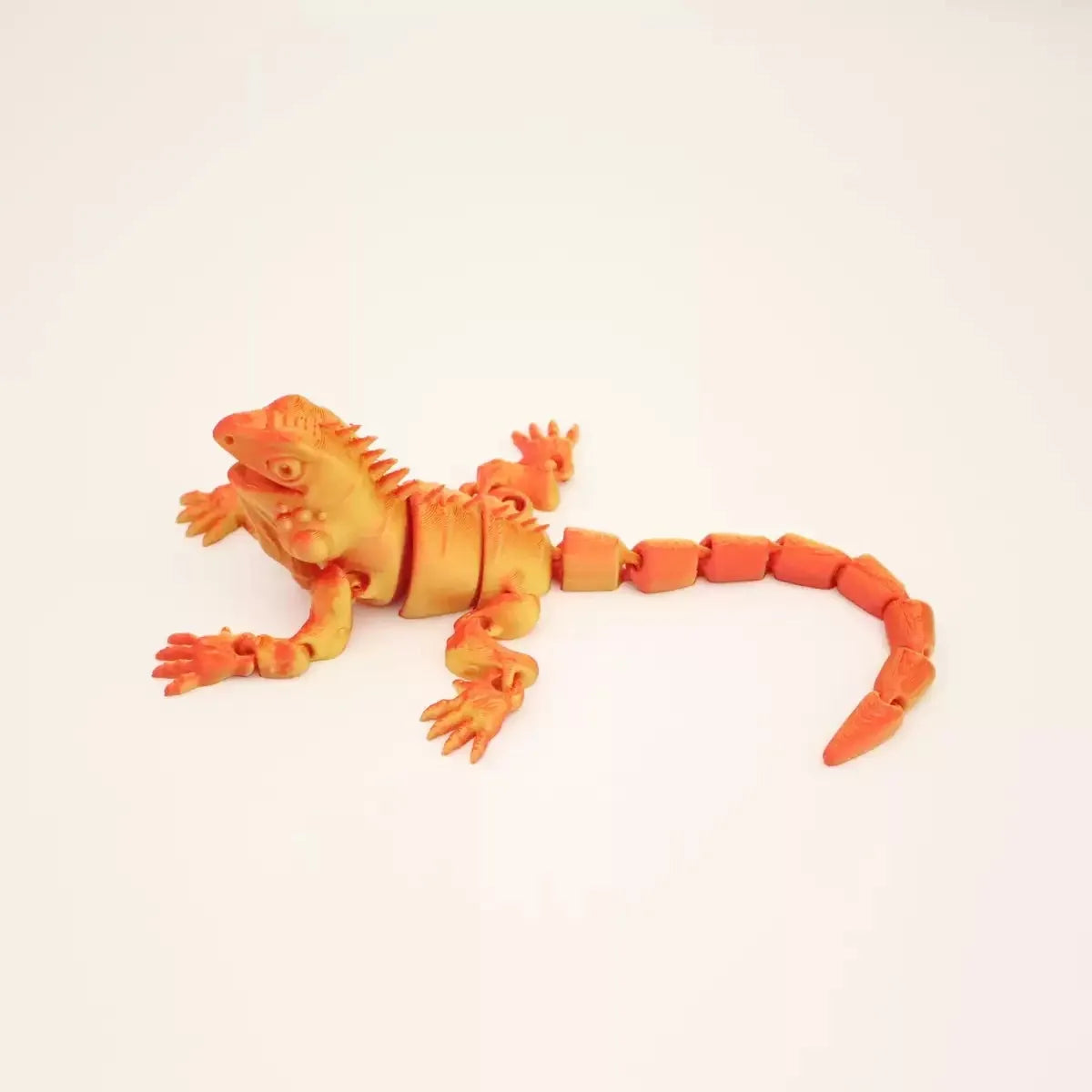 An orange articulated 3D printed lizard figurine for home decor.