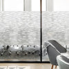 A frosted glass window privacy film is installed in a modern interior, obscuring a view of a table and chairs.