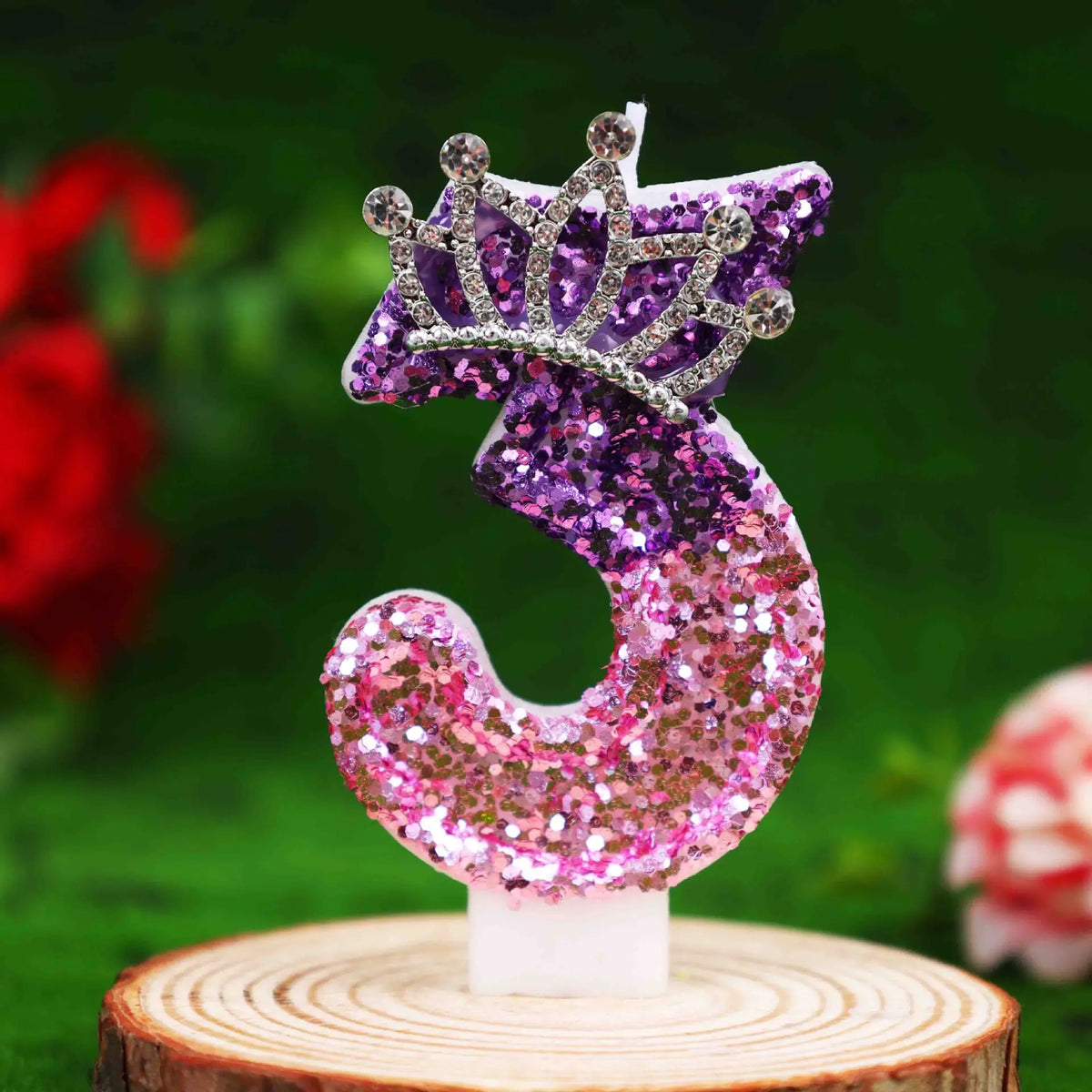 Glitter number three cake topper featuring a purple rhinestone crown and glitter numbers on a white candle.