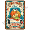 A vintage-style plaque featuring a blue truck decorated with pumpkins and autumn leaves, advertising caramel apple cider and 