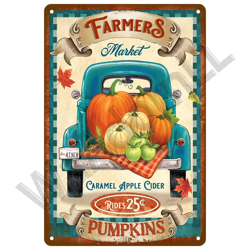 A vintage-style plaque featuring a blue truck decorated with pumpkins and autumn leaves, advertising caramel apple cider and 