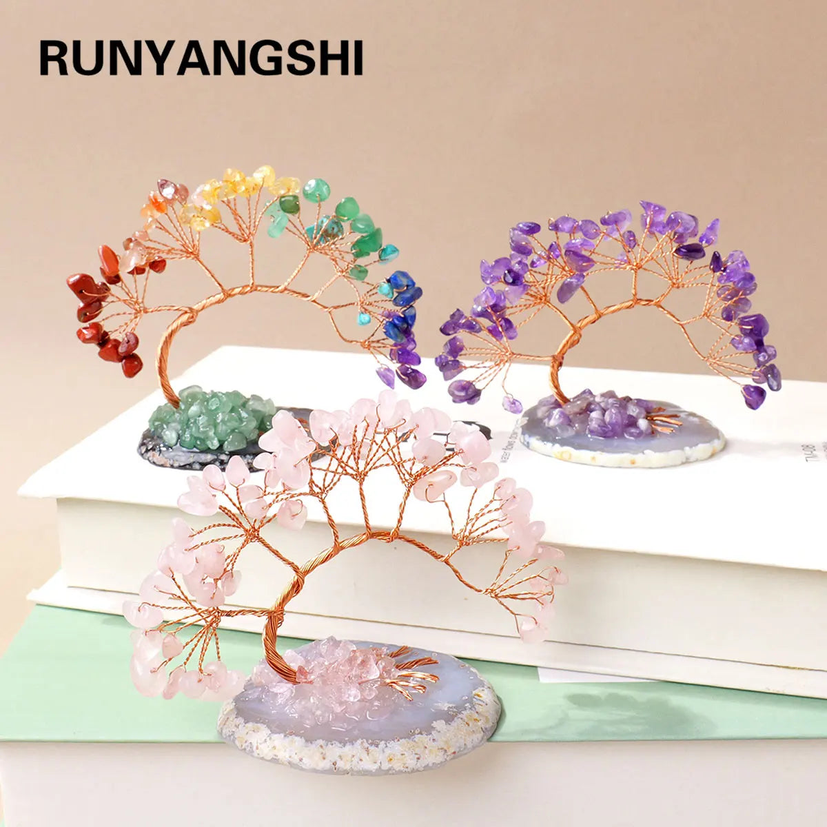 A set of natural crystal trees featuring amethyst and rose quartz on agate bases for home decor