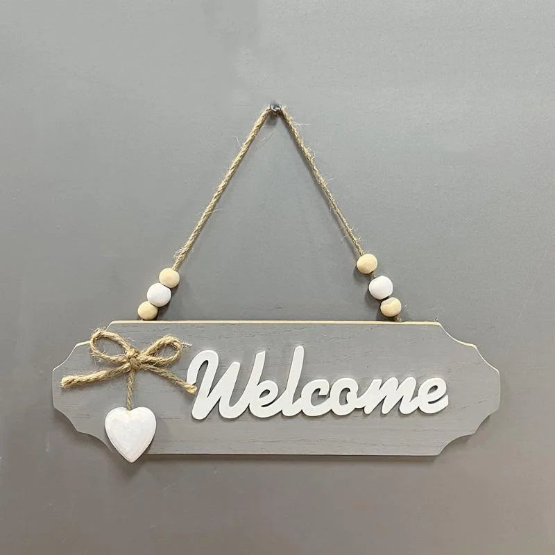 Rustic wooden welcome sign with the word Welcome carved into the wood and tied with twine.