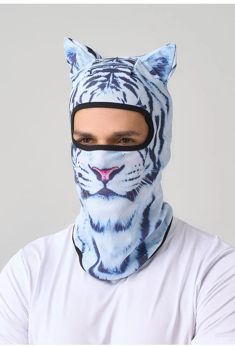 A man wearing a blue and white tiger print ski balaclava mask with cat ears.