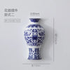 Blue and white ceramic vase with floral pattern, featuring a neck, displayed against a white background.