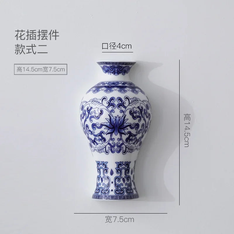 Blue and white ceramic vase with floral pattern, featuring a neck, displayed against a white background.