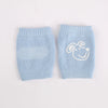 Light blue knitted knee pads for crawling infants with a white dog face design