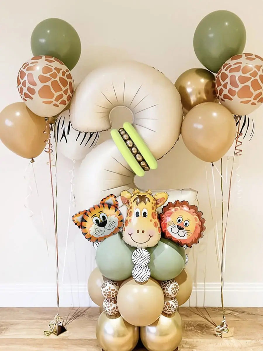 A balloon decoration featuring various sized balloons in shades of beige, olive green, and gold with animal face accents.