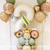 A balloon decoration featuring various shades of green and gold balloons with animal face accents.
