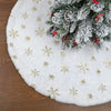 White plush Christmas tree skirt with a snowflake design and pine needles