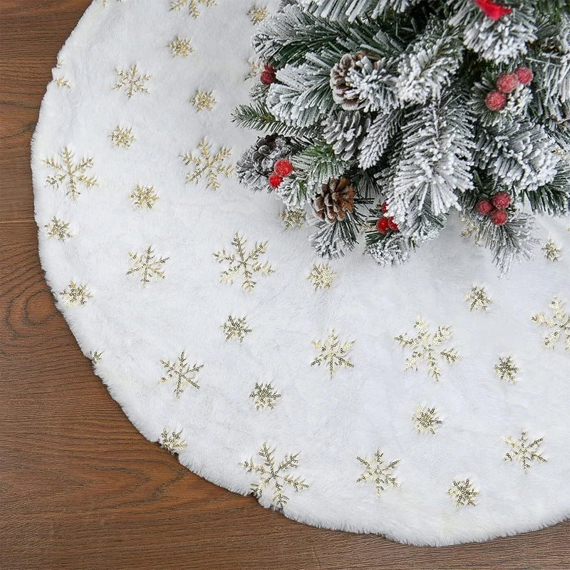 White plush Christmas tree skirt with a snowflake design and pine needles