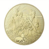 A gold-plated commemorative coin depicting a scene from the Last Supper with figures and a donkey.
