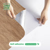 Hands peel and stick wood grain wall tiles onto a surface, demonstrating self-adhesive strong stickiness.