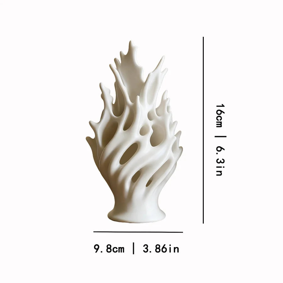 A white, sculptural plastic flower vase with wavy, organic petals shown from the side.