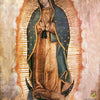 A painting of Our Lady of Guadalupe featuring a dark complexion, draped in green and gold robes against a radiant background.