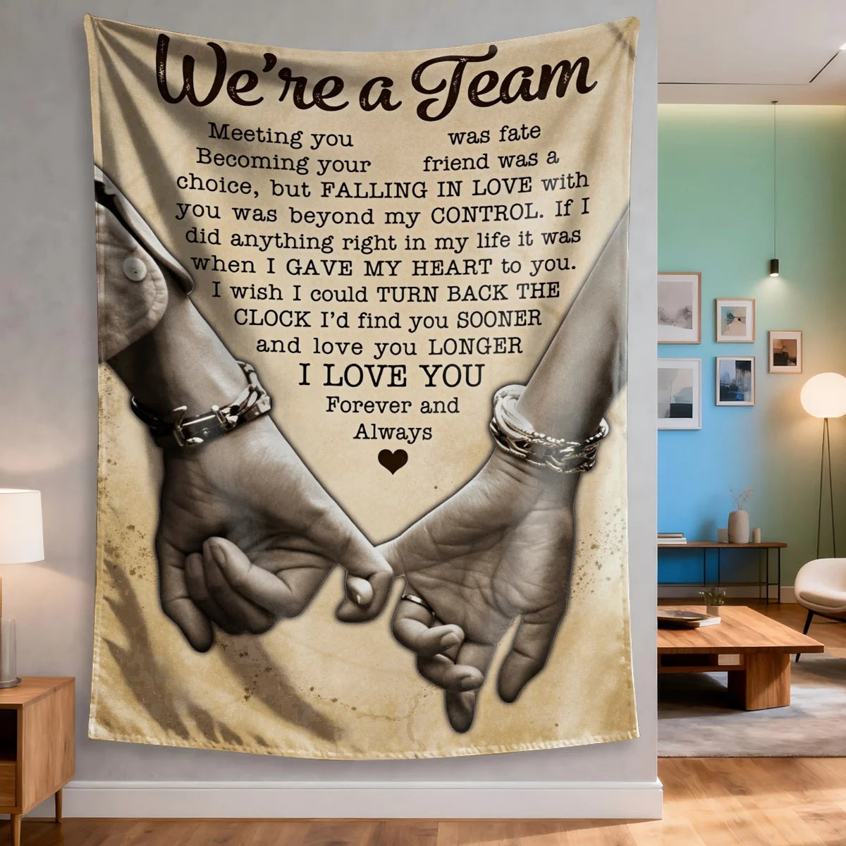 A fabric wall tapestry featuring text We're a Team and an image of two hands clasped together.