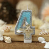 Glitter number 4 cake topper with a starfish design made of blue and gold glitter