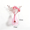 Rosa Glasflaschenvase mit getrockneten rosa Blumen und magnetischer Basis