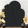A set of three black spandex wedding arch covers with gold and white spherical decorations displayed against a white wall.